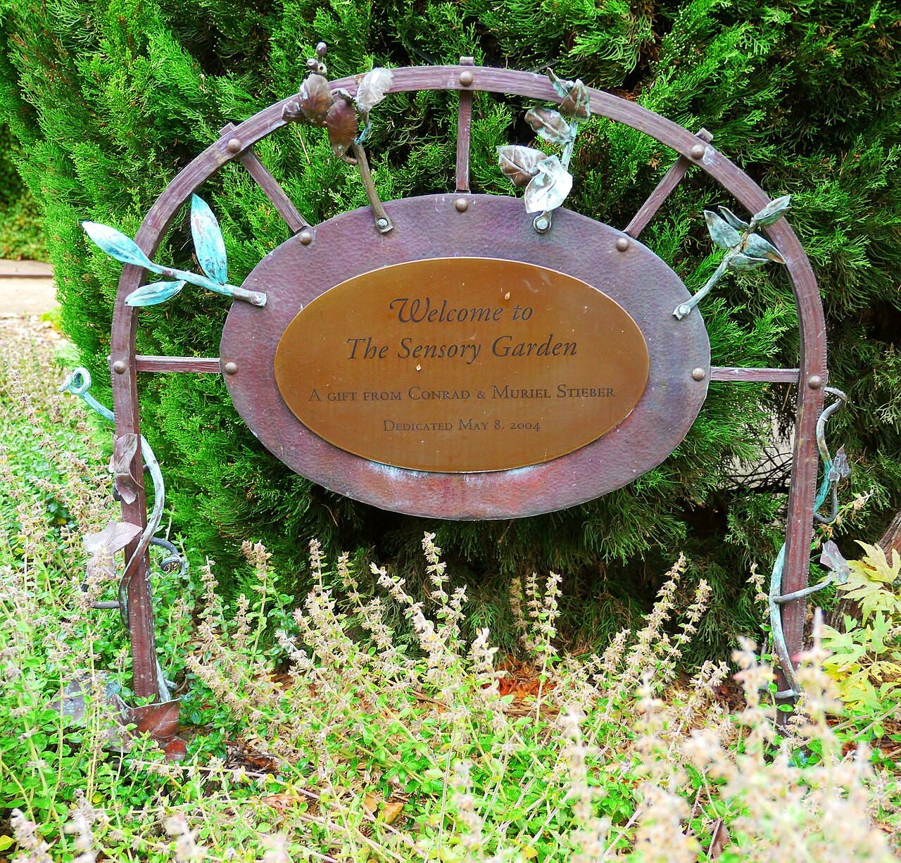 A handcrafted sign welcoming visitors to a sensory garden