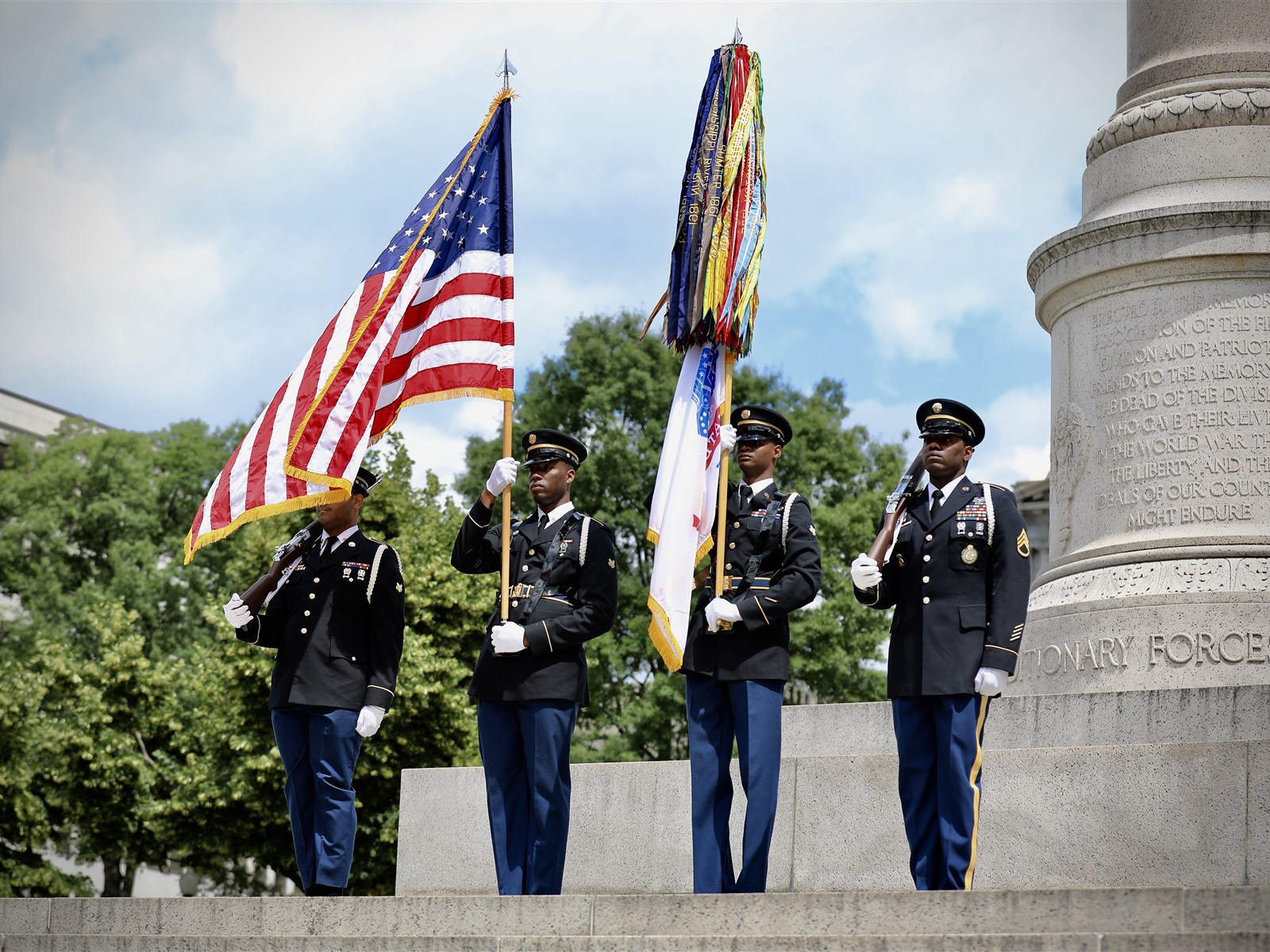 District of Columbia Army National Guard honor guardsmen presenting the United States flag at a veterans memorial